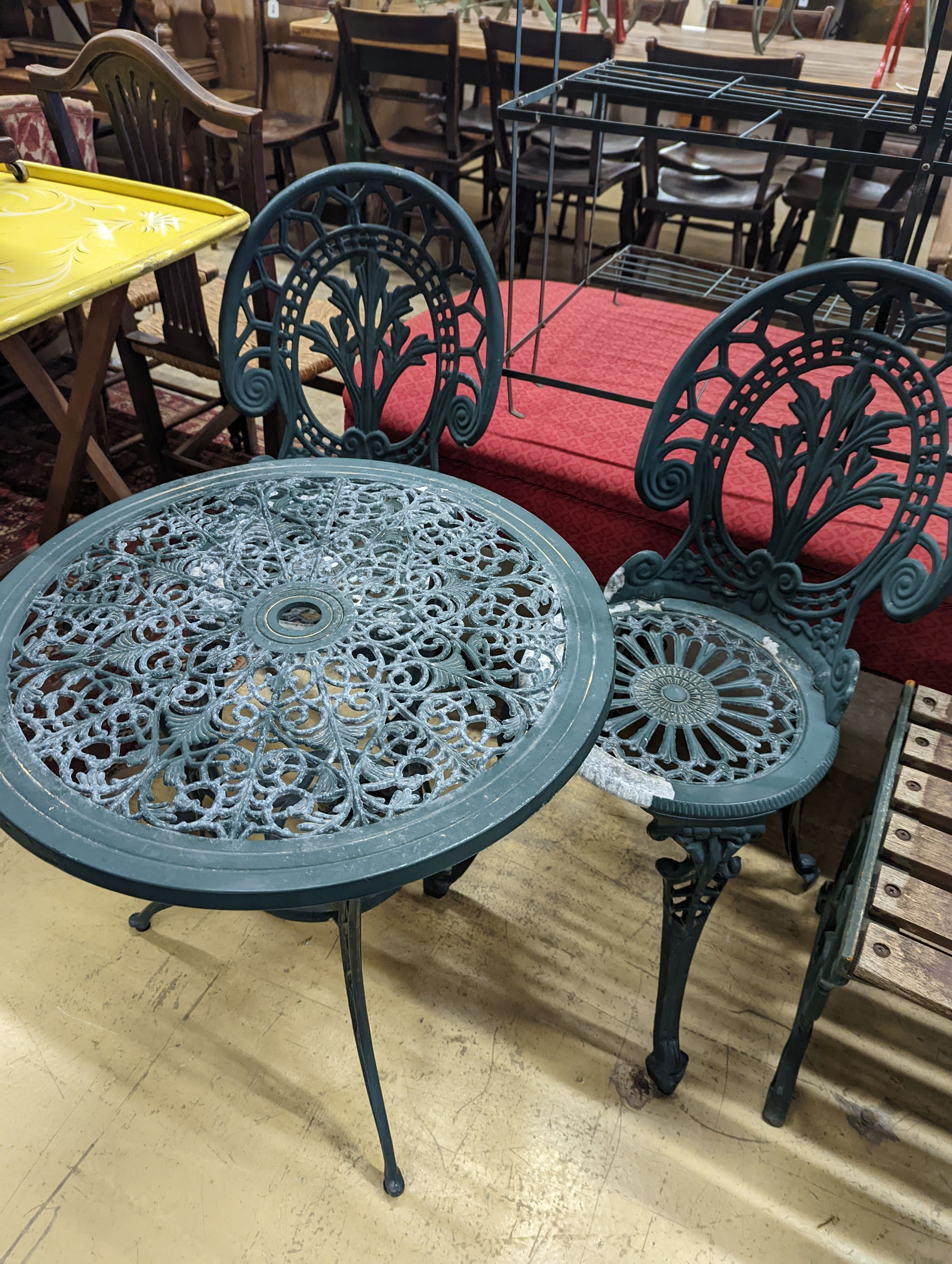 A circular painted aluminium garden table, diameter 60cm, height 62cm together with two chairs